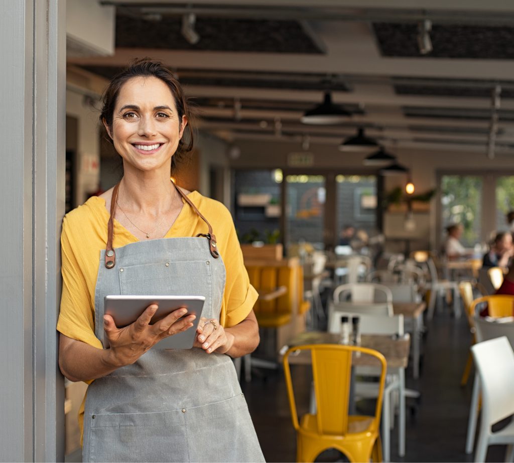 Woman standing at doorway of restaurant